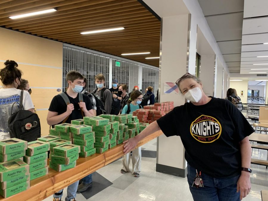 Hellgate math teacher Alexandra (Zandy) Startin poses in front of some of the 628 pies she secured for Hellgate students to celebrate Pi Day. 