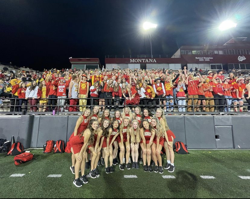 The varsity dance team posing in front of the student section at the Homecoming game. Photo courtesy of Annika Charlson. 