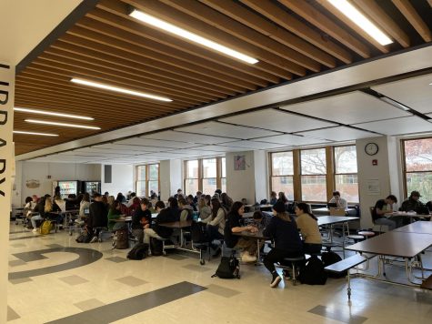 Morning classes without teachers gather in a busy commons to take attendance. Photo by Ila Bell