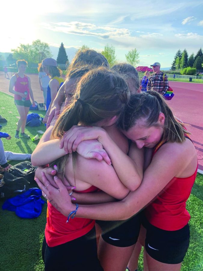 Members+of+the+Hellgate+Track+team+hug+after+the+city+meet.+Photo+by+Wilson+Freer