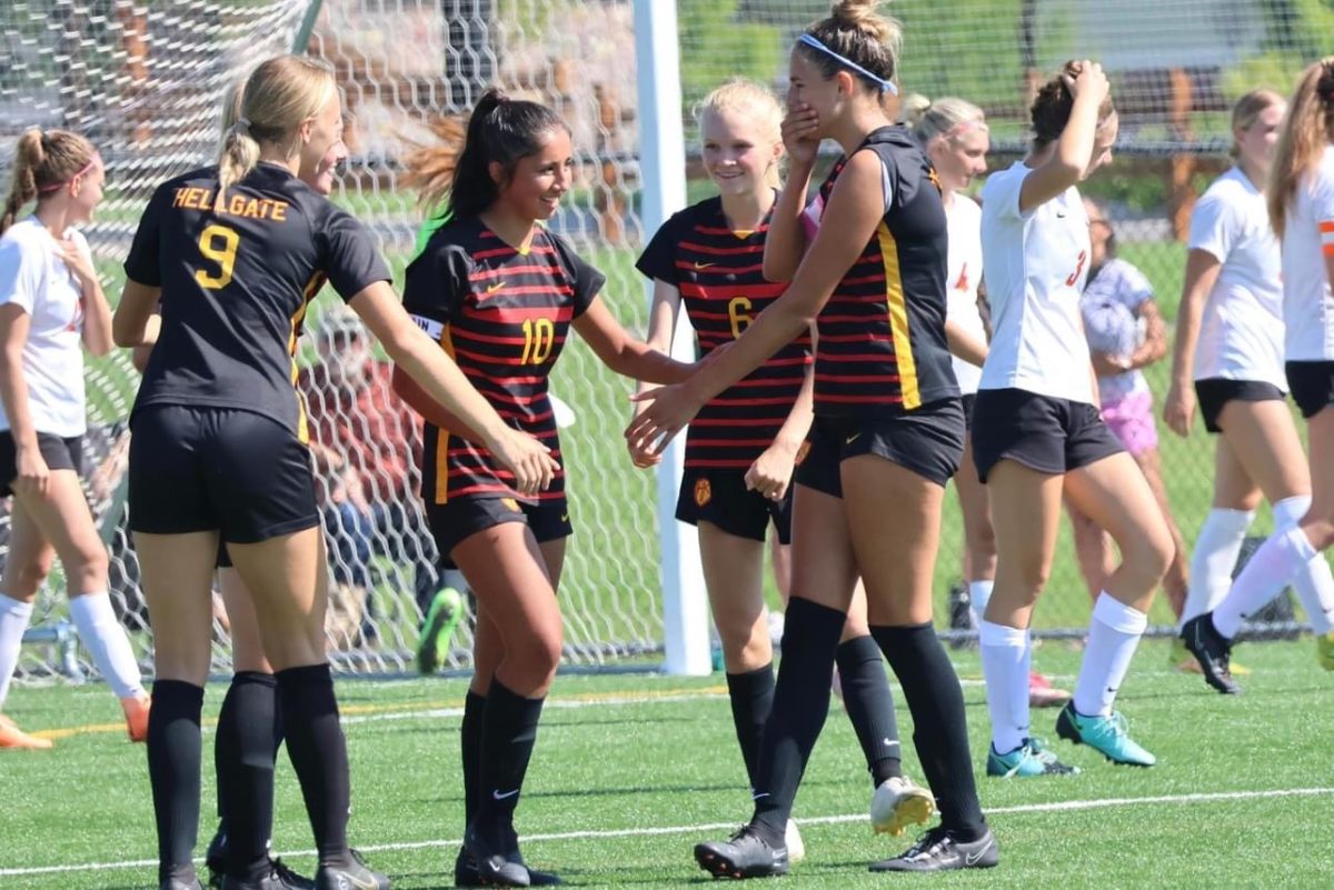 Hellgate girls celebrate after a goal on the Fort Missoula turf on Saturday 8/27