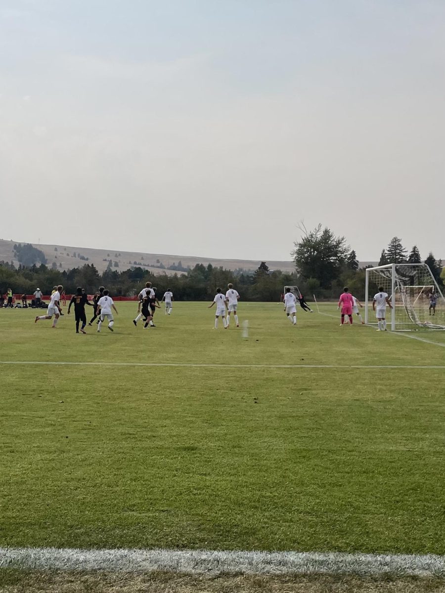 Hellgate boys varsity on a corner kick against Butte. Photo by Mai McKelvey-Pham. 