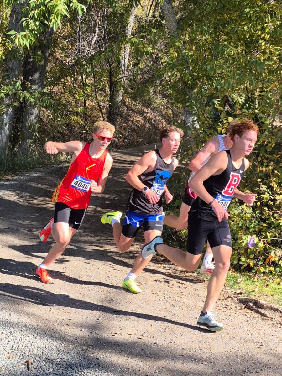 Charlie Gruber, Hellgate varsity sophomore, rounds a corner at the Helena 7 of 7 meet. The Hellgate boys had stiff competition this year with Bozeman, and fought to the end in an attempt to claim the state championship. Photo by Sabine Glaser
